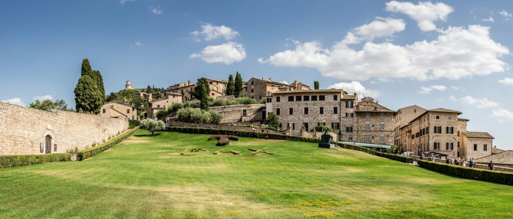 Assisi hillside with olive trees, cypresses and medieval stone houses
